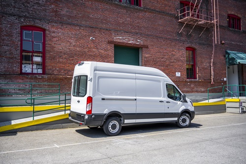 a van parked in front of a building